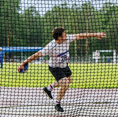 a person preparing to perform a discus throw